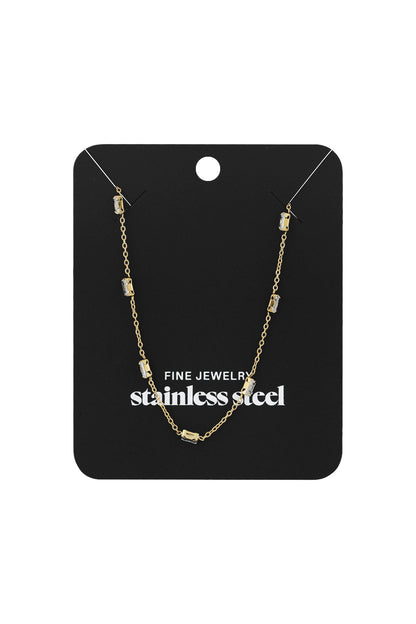 Gold crystal chain necklace displayed on black jewelry card labeled 'stainless steel fine jewelry' packaging