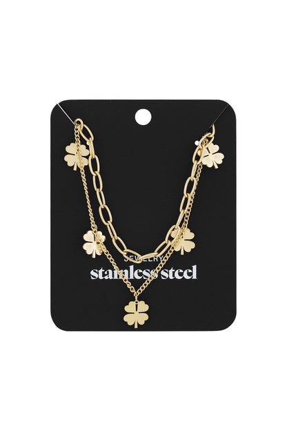 Gold layered necklace with clover charms displayed on black card labeled stainless steel