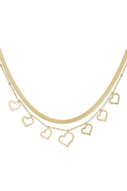 Close-up image of dainty gold layered necklace with seven open-heart charms on fine chains against white background