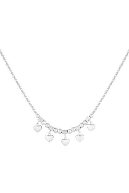 Silver-toned version of the heart charm necklace with five small heart pendants on a sleek chain against a white background