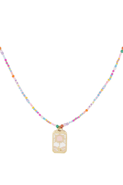 Close-up of a colorful beaded necklace with pink and pastel beads and a gold-tone sun charm pendant with pink center