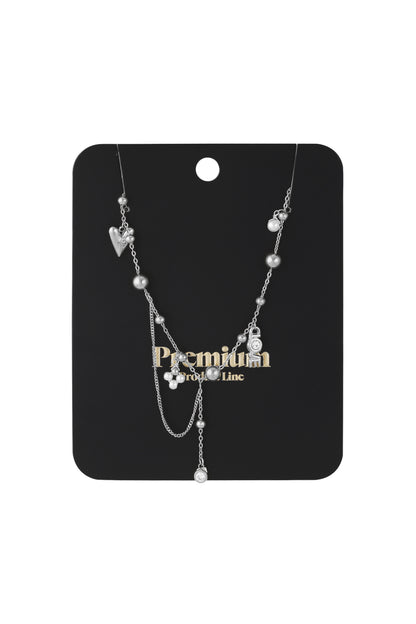Silver charm pendant necklace displayed on black packaging card with 'Premium' branding