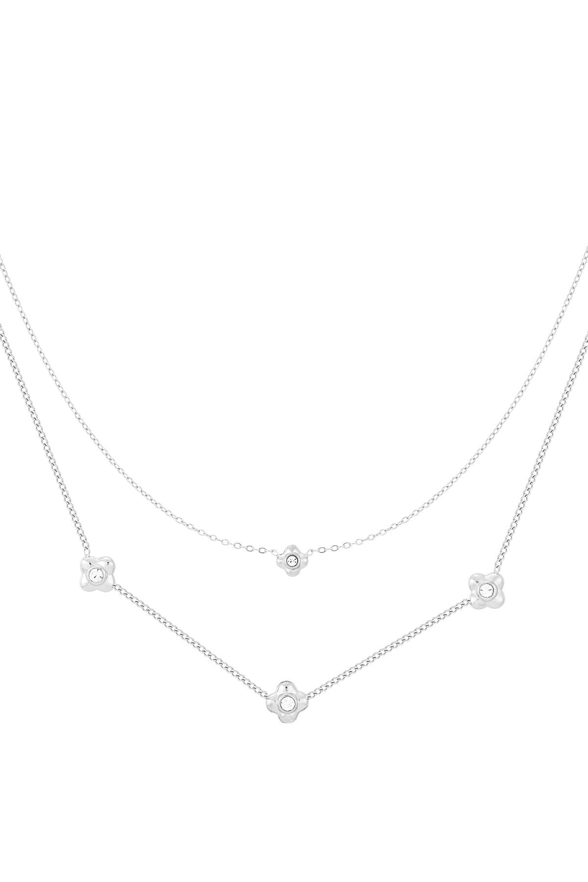 Close-up of silver tone layered necklace featuring flower-shaped rhinestones on white background