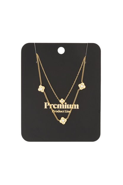 Gold tone layered flower necklace on black card packaging labeled premium, highlighting elegant presentation