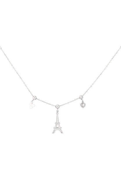 Silver-tone charm necklace featuring an Eiffel Tower centerpiece flanked by small heart and flower charms on a fine chain.