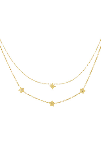 Close-up of gold multi-layered star necklace with star charms and rhinestones