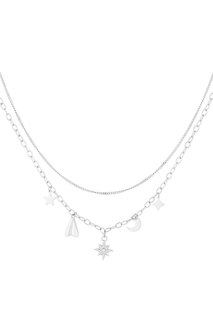 Silver layered necklace with celestial charms similar to the gold version on white background
