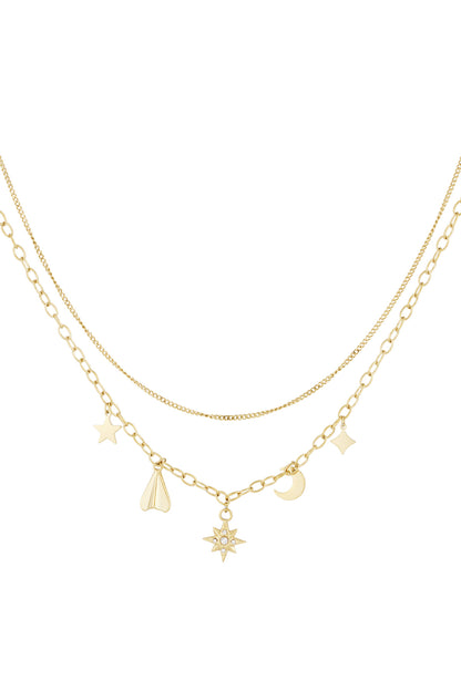 Gold layered necklace with delicate celestial charms including star, moon, and rhinestone star on white background