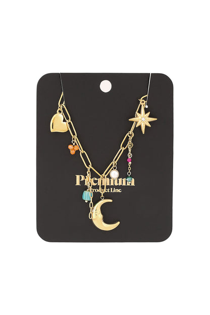 Gold pendant necklace displayed on black card with 'Premium' branding visible