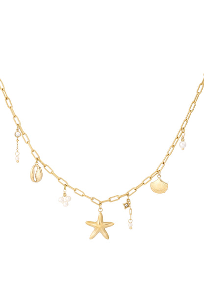 Gold charm necklace featuring starfish, shell, cowrie, crystals and pearl accents displayed on white background