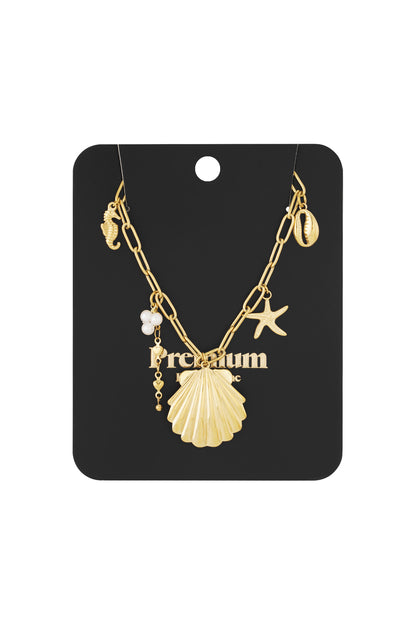 Gold charm necklace displayed on black branded packaging card featuring all ocean-themed charms clearly visible.
