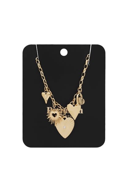 Gold link necklace with heart and sunburst-shaped charms displayed on black card packaging