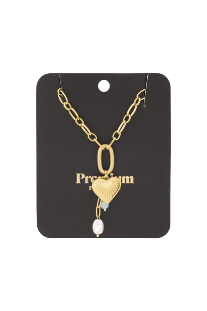 Gold heart charm necklace displayed on black Premium jewellery card packaging