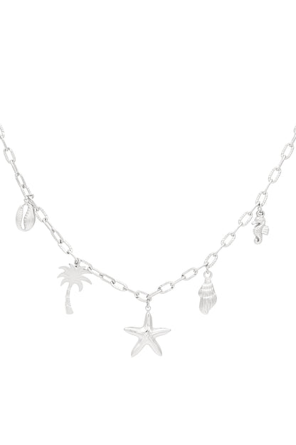 Close-up of silver seaside charm necklace with similar seaside charms on medium-link chain, highlighting shiny finish