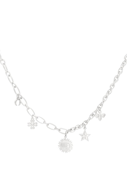 Silver charm necklace with same sun, star, bee, flower and moon charms on mixed chains against white background