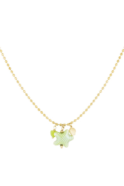 Gold-tone necklace with a green starfish charm, green heart bead, and gold seashell charm on a fine bead chain against white background