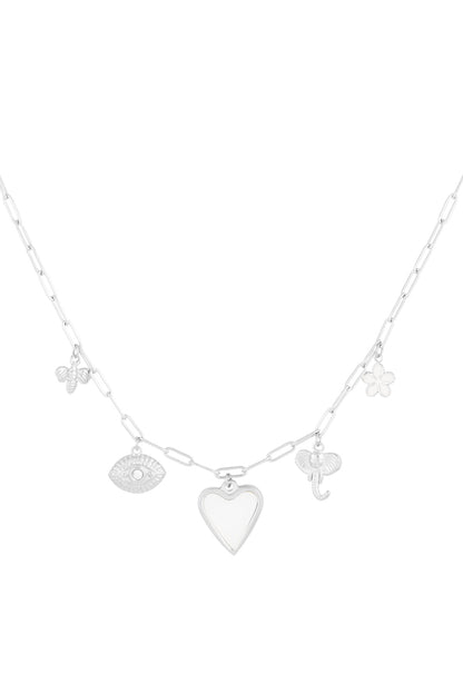 Silver tone charm pendant necklace with heart, bee, eye, elephant, and flower charms on paperclip chain against white background