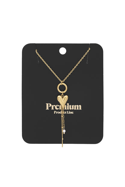 Gold heart charm pendant necklace displayed on black Premium Product Line card