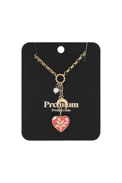 Gold-tone charm necklace displayed on black 'Premium Product Line' card showing red heart, crescent moon, and pearl charms