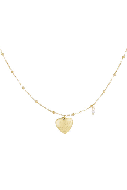 Gold heart charm pendant necklace with bead chain and small pearl accent on white background