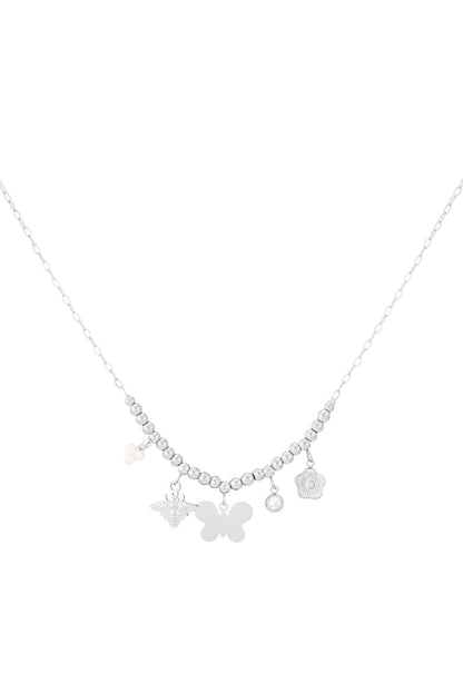 Silver charm beaded necklace with butterfly, bee, pearl and floral charms on white background
