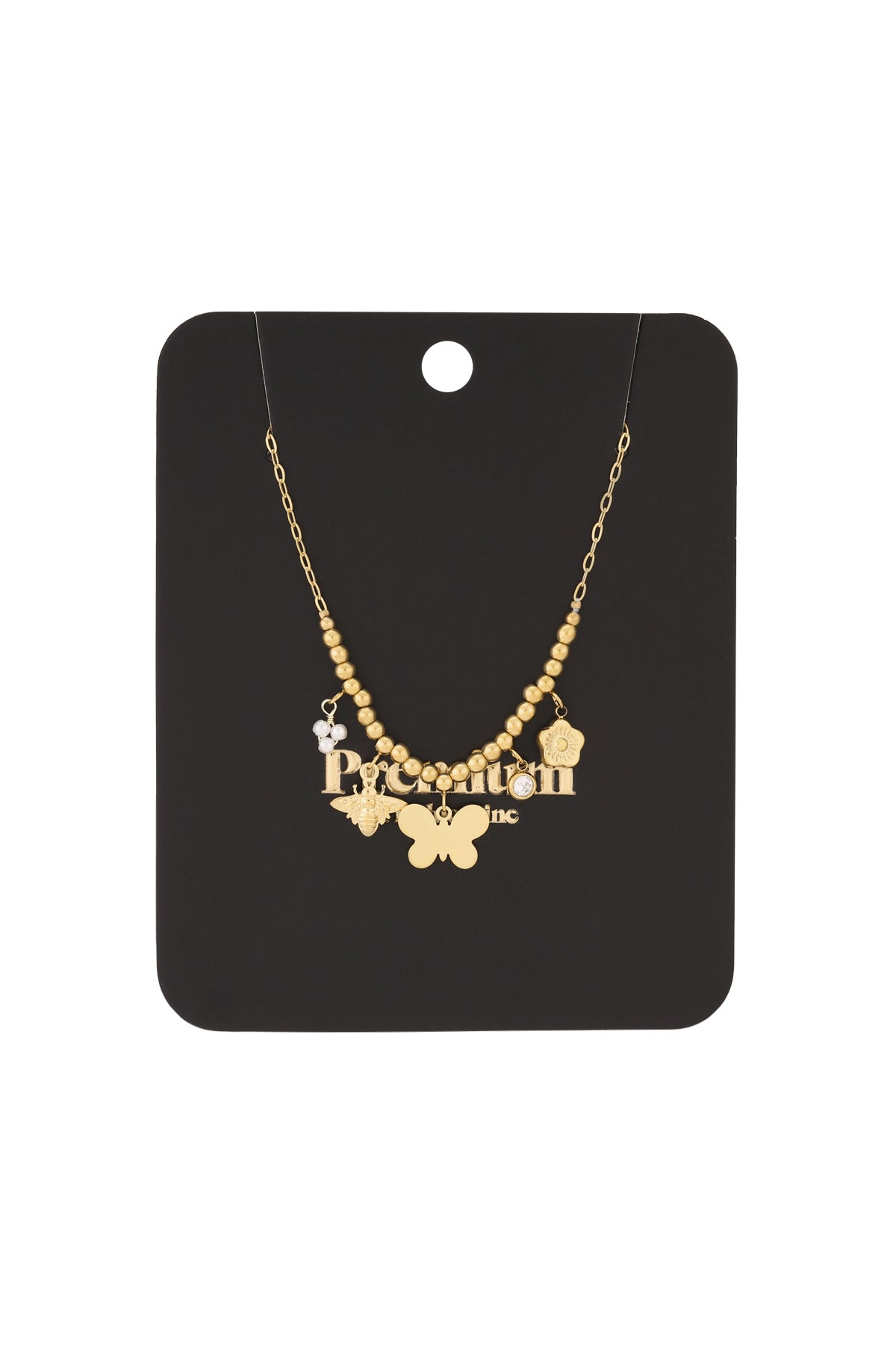 Gold charm beaded necklace displayed on black branded packaging card