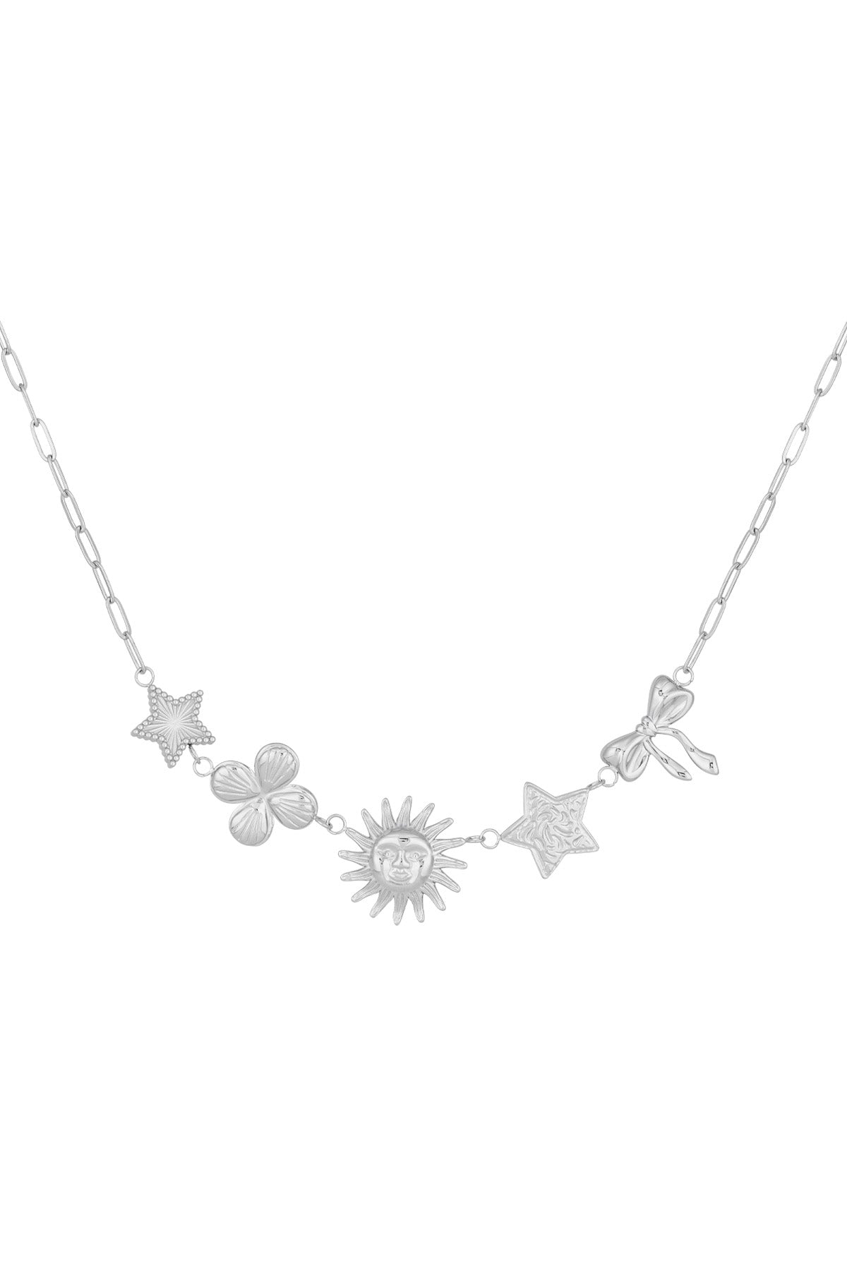 Silver-tone celestial charm necklace with star, clover, sun, textured star, and bow charms laid flat on white background