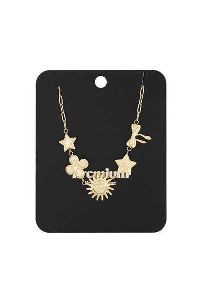 Gold-tone celestial charm necklace displayed on a black jewellery card with ‘premium’ label