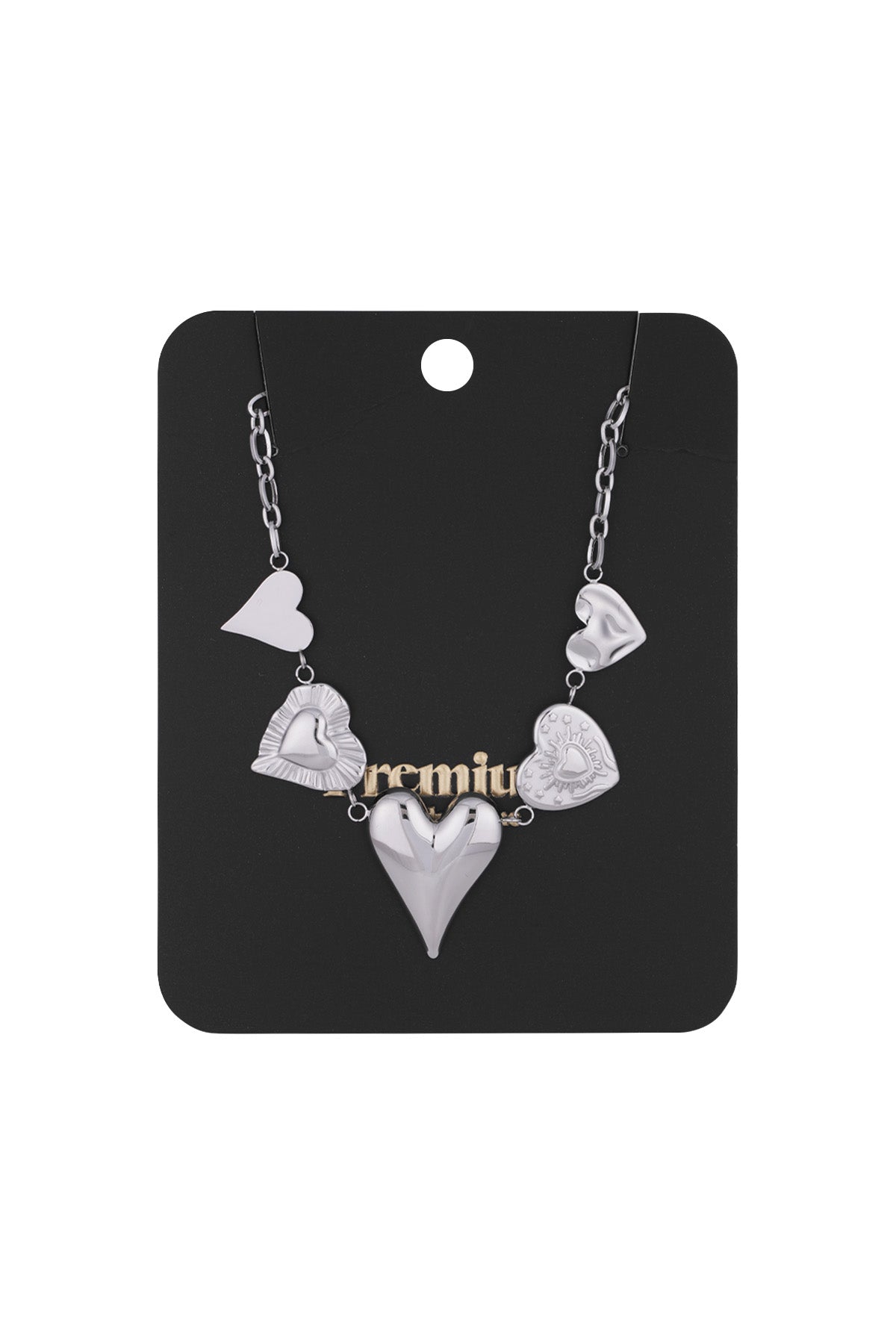 Silver multi heart charm necklace displayed on black premium packaging card