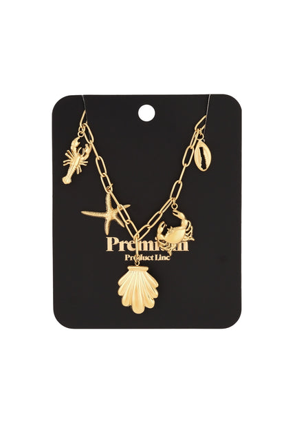 Gold seaside charm necklace displayed on black product card with elegant branding