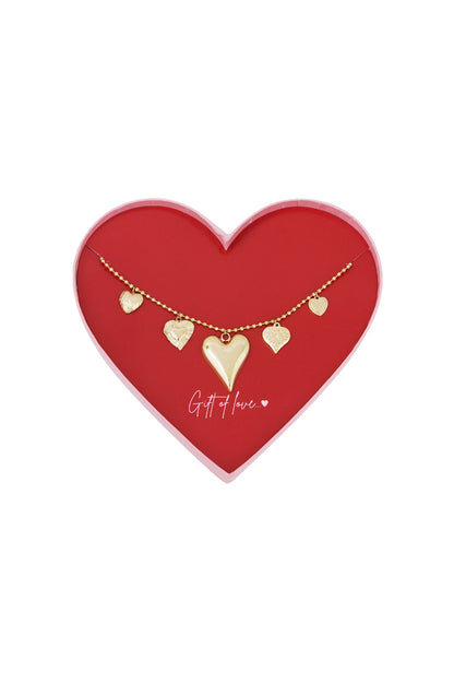 Gold-toned stainless steel necklace with five textured heart charms displayed in a red heart-shaped box inscribed with 'Gift of love..'