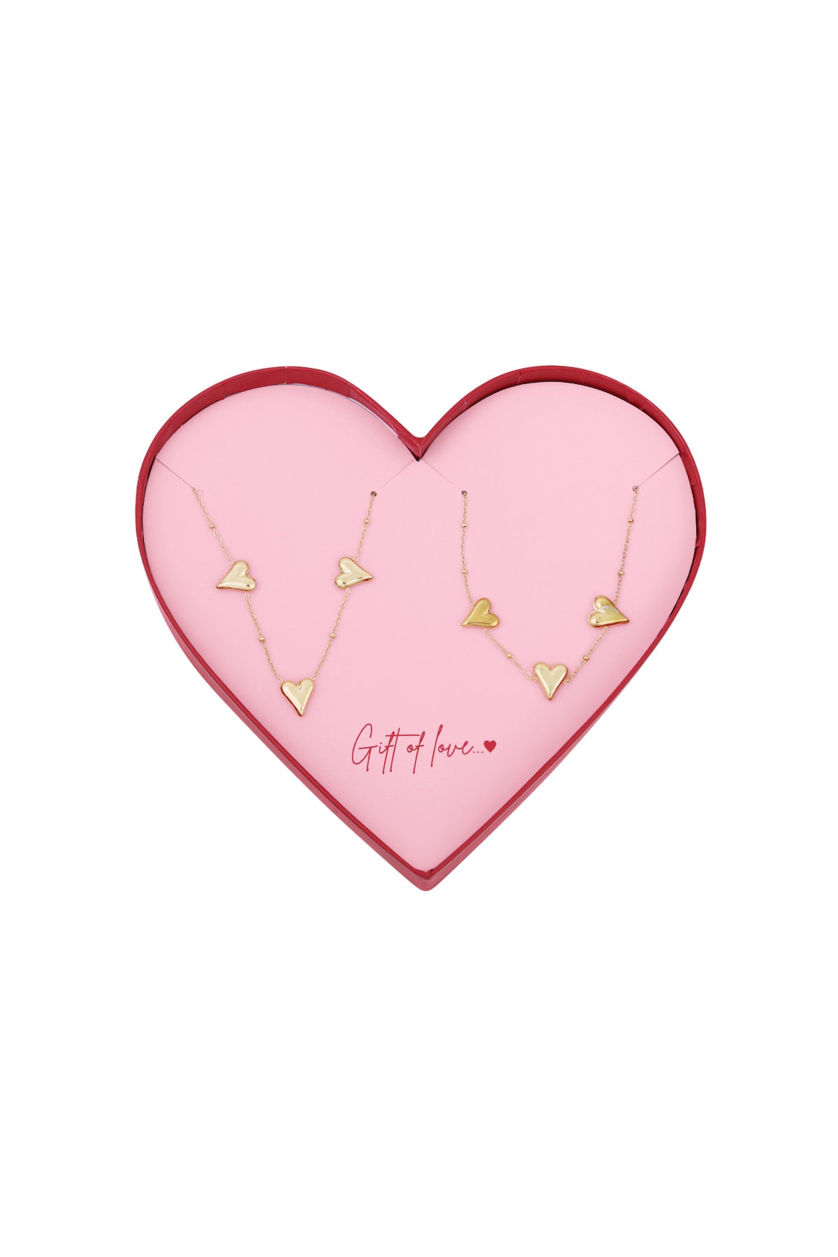 Gold-tone heart charm necklaces displayed in a pink heart-shaped gift box with red edges and the phrase 'Gift of love' inside