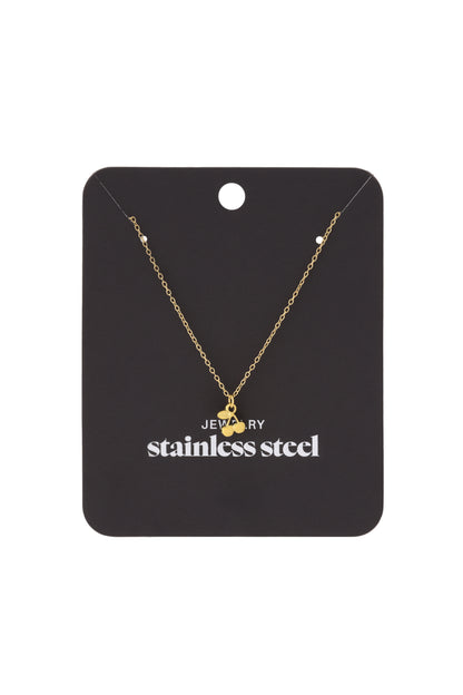 Golden cherry pendant necklace displayed on a black card labeled stainless steel jewelry