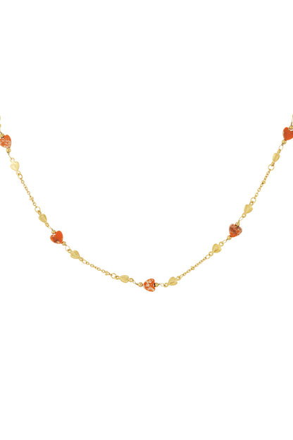 Full shot of gold-tone chain necklace with turquoise and gold heart-shaped beads on white background