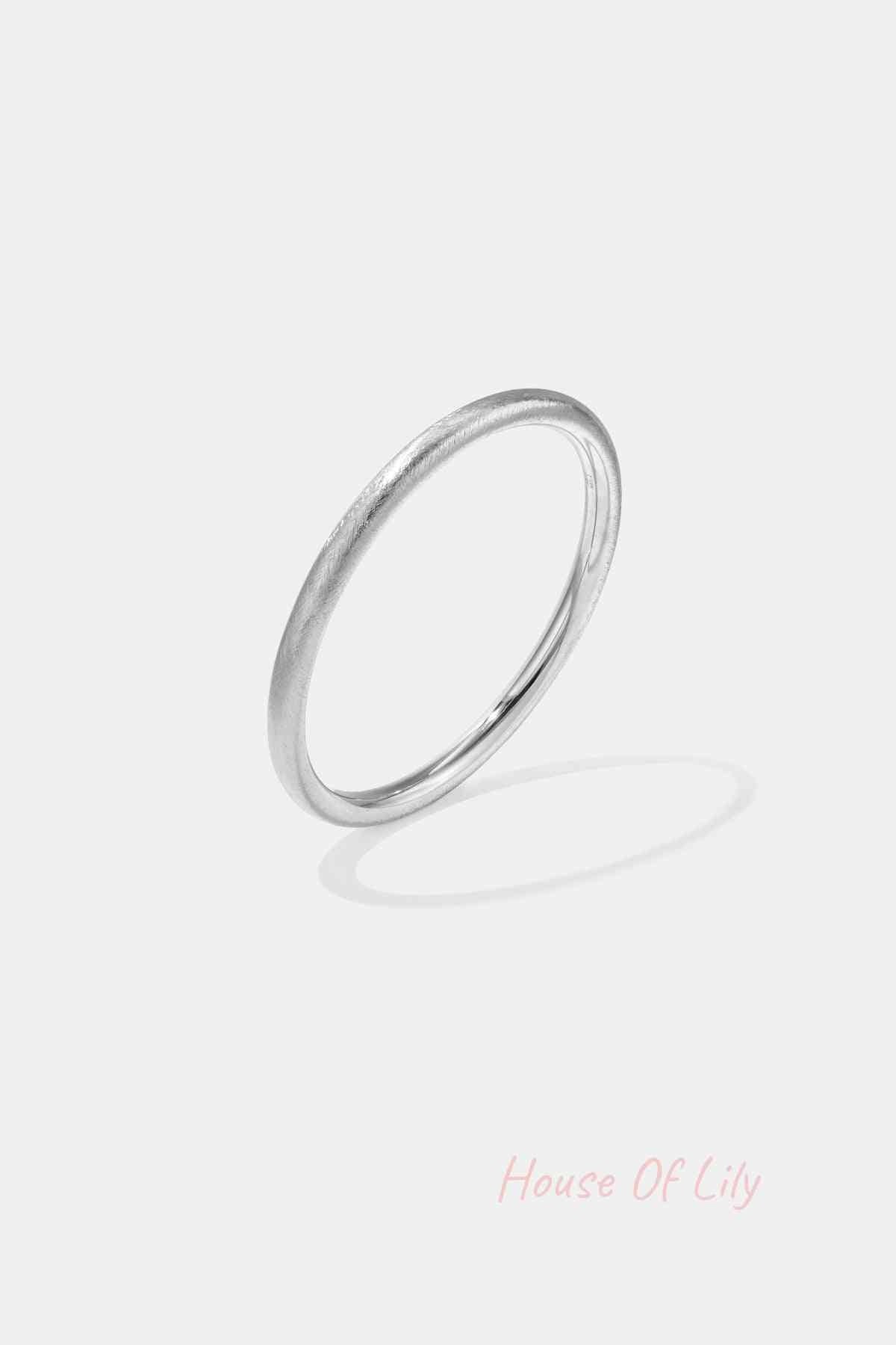 Minimalist silver brushed metal circle bangle isolated on white background