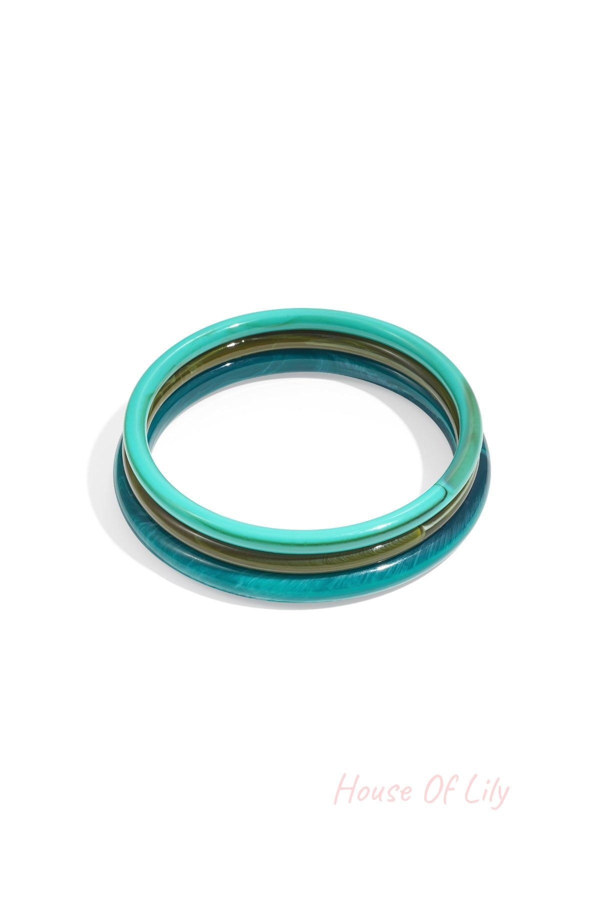 Stack of three blue and green resin bangles with glossy finish isolated on white