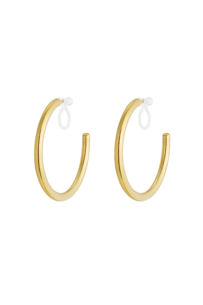 Pair of polished gold-tone clip-on hoop earrings with clear silicone loops on white background