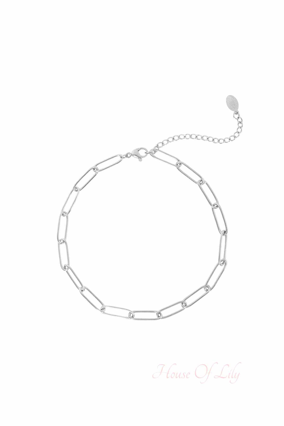 Silver-tone chain link anklet with lobster clasp and extension chain on a white background