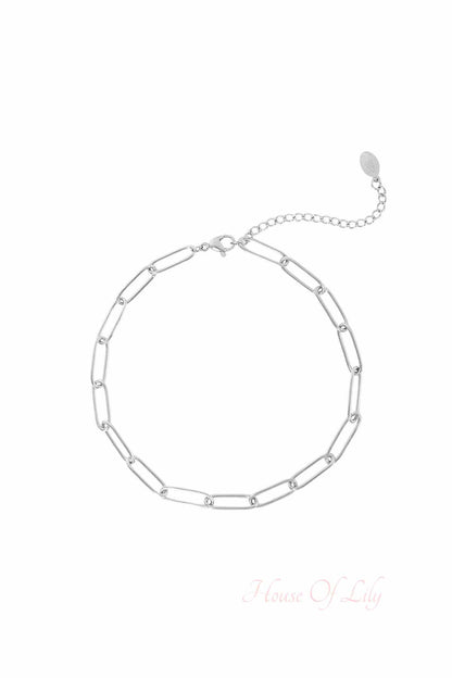 Silver-tone chain link anklet with lobster clasp and extension chain on a white background