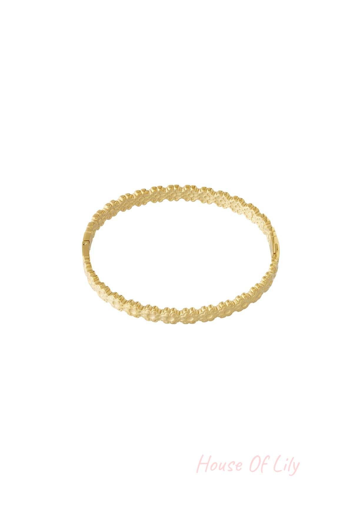 Gold floral detail bangle bracelet with delicate flower pattern