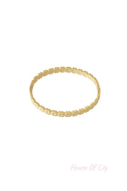 Gold floral detail bangle bracelet with delicate flower pattern