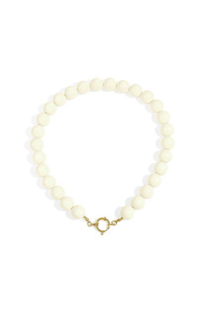 Chunky beige resin beaded necklace with gold clasp on white background