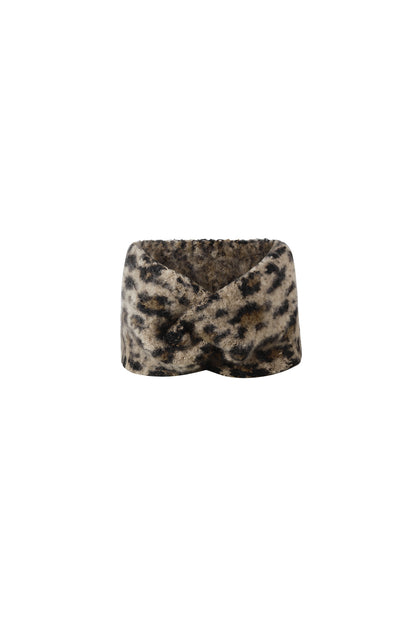 Close-up of cozy leopard print twisted headband showing plush texture and warm colors
