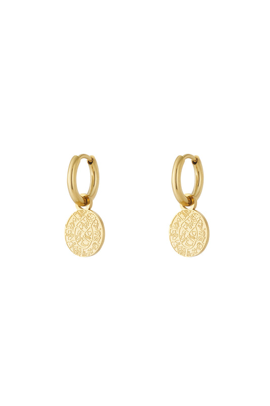 Pair of gold astro charm hoop earrings with engraved round pendants on a white background