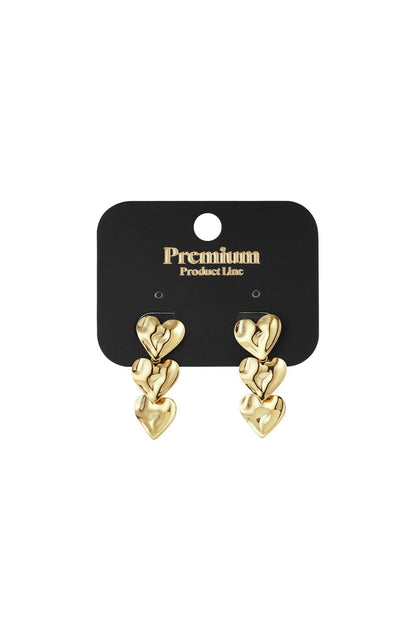 Brushed gold drop earrings featuring a trio of interconnected, organic-shaped hearts on a black display card.