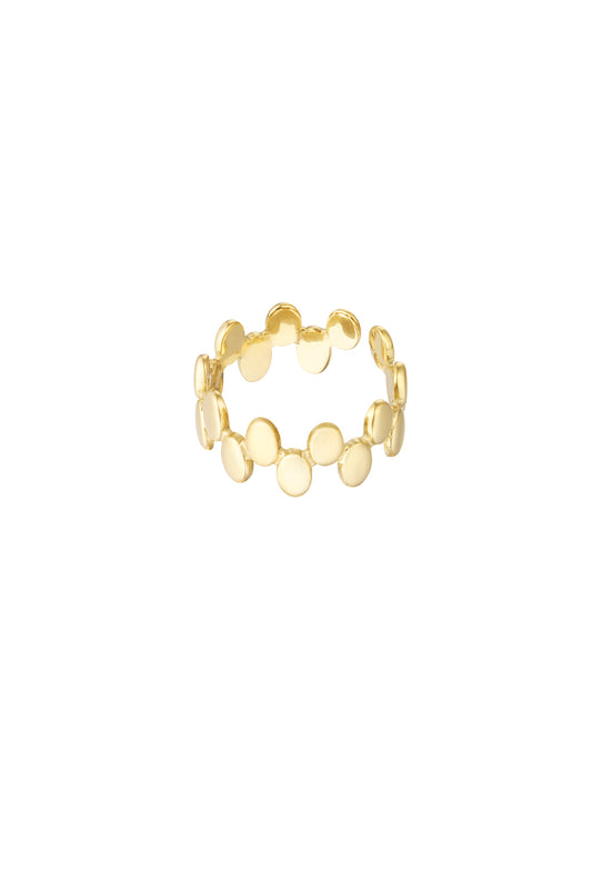 Close-up of a gold open band ring with linked smooth disc shapes against a white background