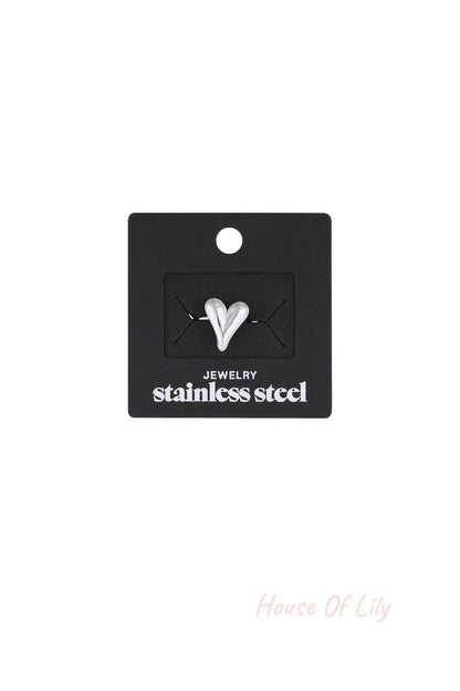 Silver heart statement ring displayed on black packaging card labeled stainless steel jewelry