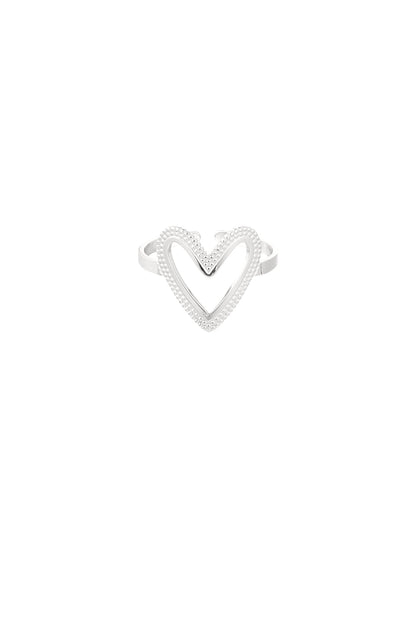 Silver-toned heart-shaped ring with textured beading shown against white background