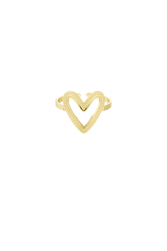 Close-up of a gold-toned heart-shaped ring with textured beading on white background
