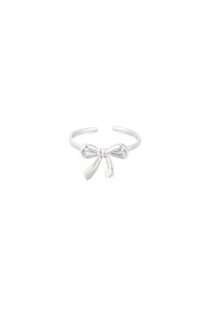 Close-up of silver bow accent minimalist open ring on white background